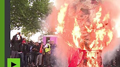 « Au bûcher ! » : une tête de Macron, une balle entre les yeux, brûlée à la manifestation du 22 mai
